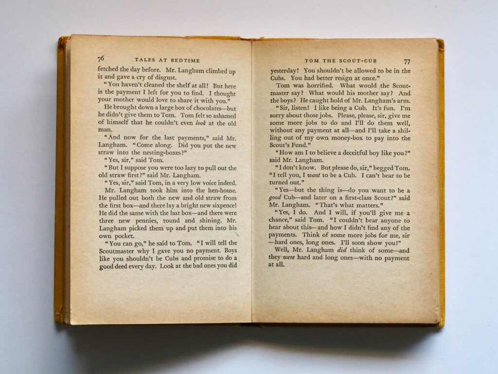 pexels-photo-762687-762687 Vintage book opened to pages 76-77, displaying classic literature text in soft lighting.